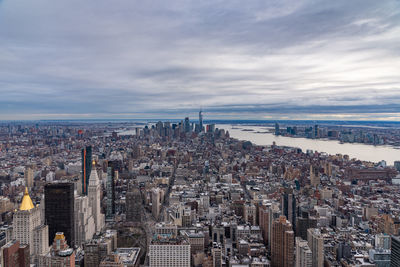 High angle view of buildings against cloudy sky