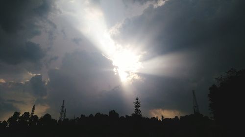 Low angle view of silhouette trees against sky