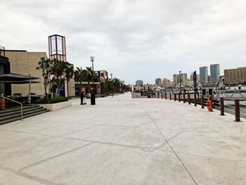 Street amidst buildings in city against sky