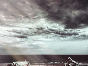 Scenic view of sea against storm clouds