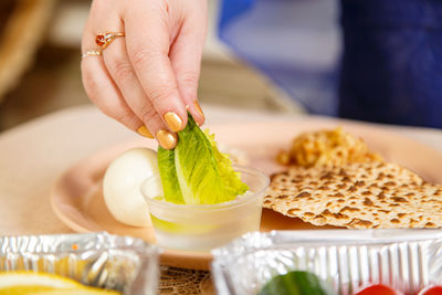 Midsection of person preparing food on table