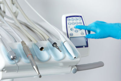 Cropped hand holding dental equipment