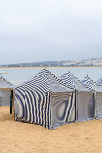  tents on the beach against the sky