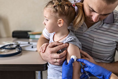 A little girl in the doctor's . the concept of vaccination, prevention against covid-19