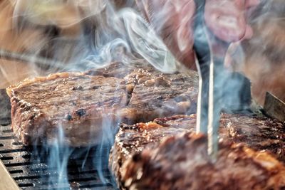 Close-up of preparing food on barbecue grill