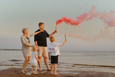 Full length of couple standing at beach