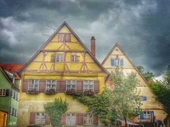 Low angle view of building against cloudy sky