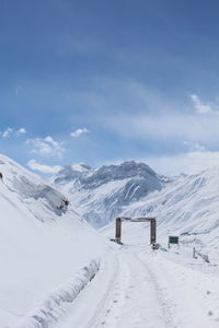 Scenic view of snow covered mountains against sky