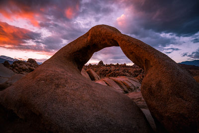 Low angle view of rock formations against sky during sunset