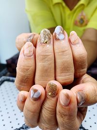 Midsection of woman showing nail art