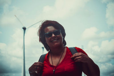 Portrait of smiling man wearing sunglasses against sky