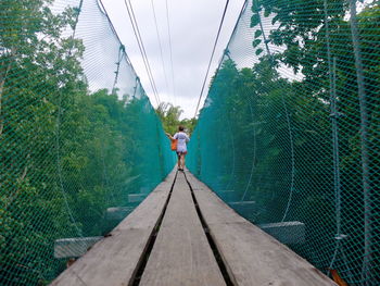 Woman walking on bridge