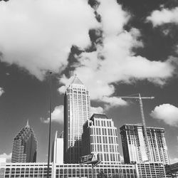 View of skyscrapers against cloudy sky