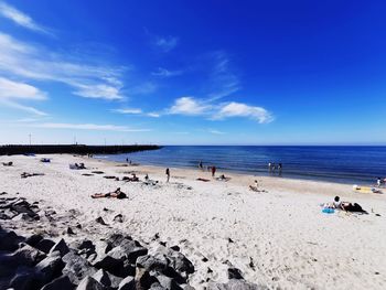 Scenic view of beach against blue sky