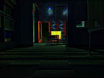 Empty seats in illuminated building at night