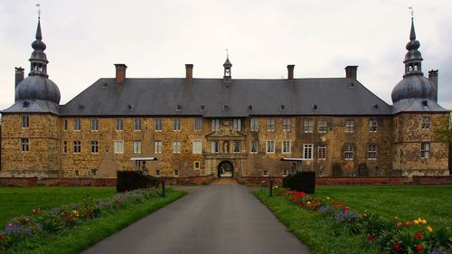 Pathway leading to built structure against the sky