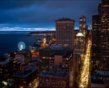 High angle view of illuminated cityscape against sky at night