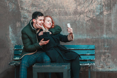 Young couple sitting on bench