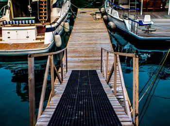 Pier amidst boats moored on lake