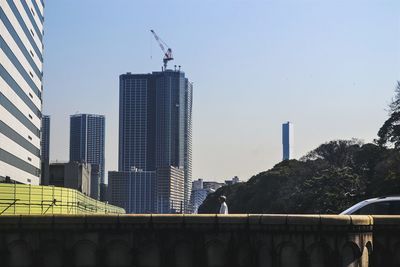 Buildings in city against clear sky