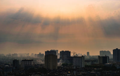 Cityscape against sky during sunset