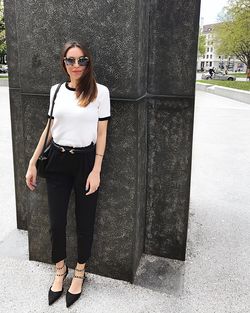 Portrait of young woman wearing sunglasses standing outdoors