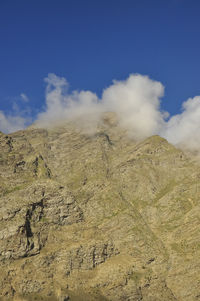 Morning view of dry mountain covered from the peak with clouds in darcha, lahaul and spiti, himachal 