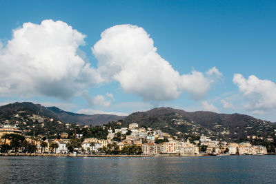 Town by sea against sky