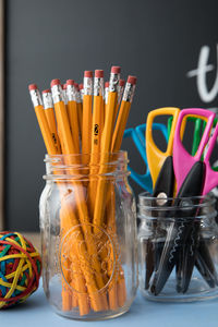 Close-up of pencils in jar at desk