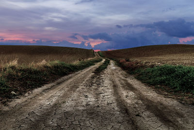 Dirt road along countryside landscape