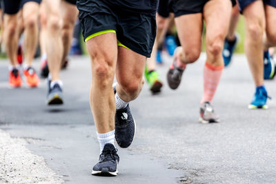 Low section of runners in marathon race on city street