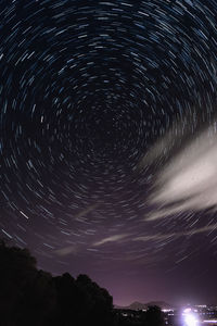 Low angle view of fireworks against sky at night