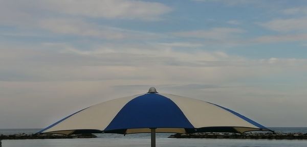 Tent by sea against sky