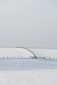 Scenic view of sea against clear sky during winter