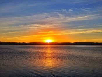 Scenic view of sea against romantic sky at sunset