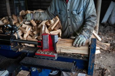 Midsection of man working at workshop