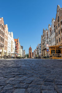 Buildings in the city against clear blue sky