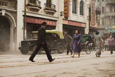 People walking on road in city