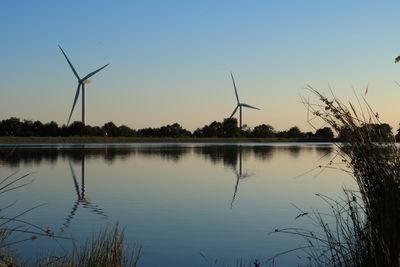 Wind turbines in calm blue lake