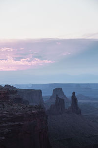 Rock formations on landscape against sky during sunset