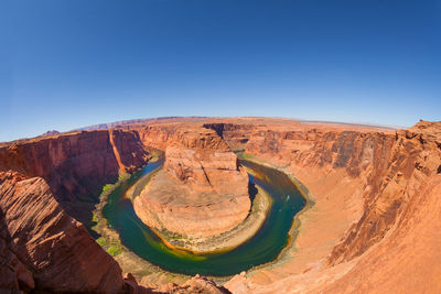 Scenic view of rock formations against blue sky