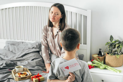 Mother and son on bed