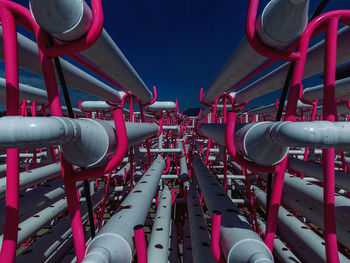 Low angle view of industry against blue sky