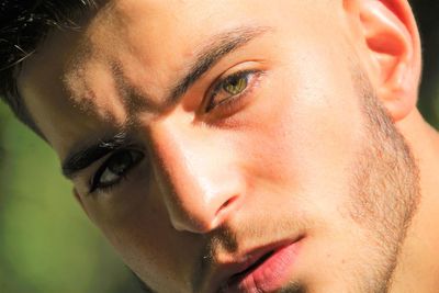 Close-up portrait of young man looking away