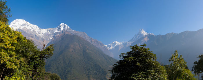 Scenic view of mountains against clear blue sky