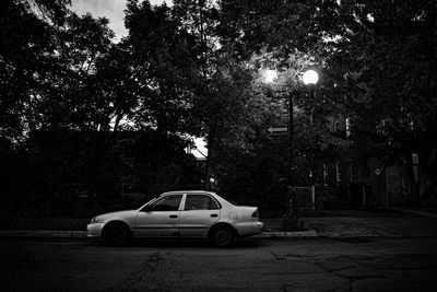Car on illuminated street light at night
