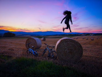 Full length of person on field against sky during sunset