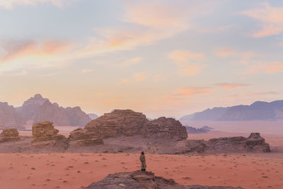 Rock formation on land against sky during sunset