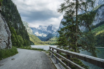 Scenic view of river by mountains against sky