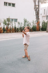 Full length of girl walking on road